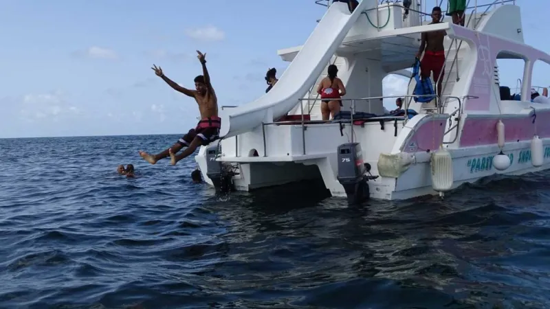 boy going down slide on boat