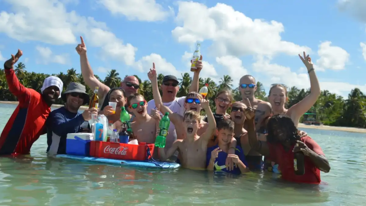 people posing for camera with drinks in hand