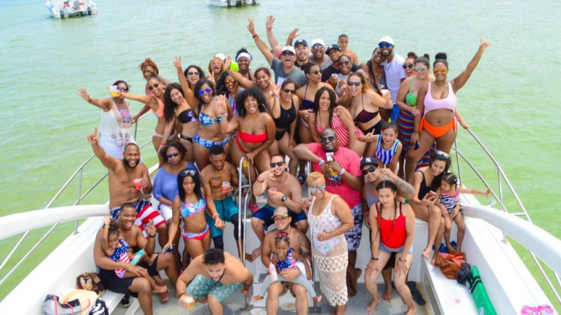 group of people posing for picture on a boat