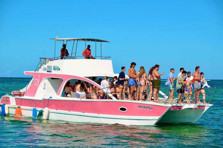 a group of people in a small boat in a body of water