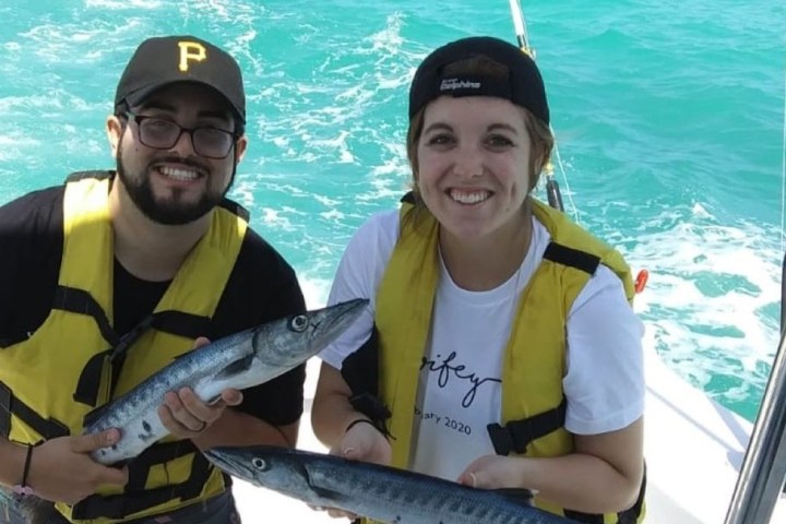 a person holding a fish in the water
