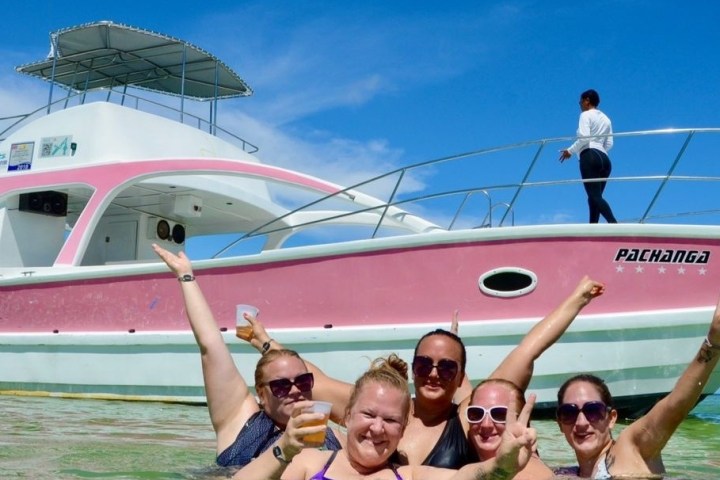 a group of people on a boat posing for the camera