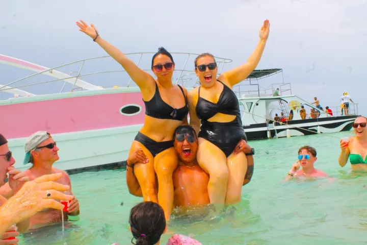 a group of people standing next to a body of water