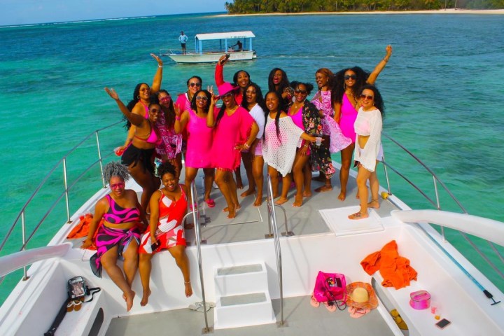 a group of people standing next to a body of water