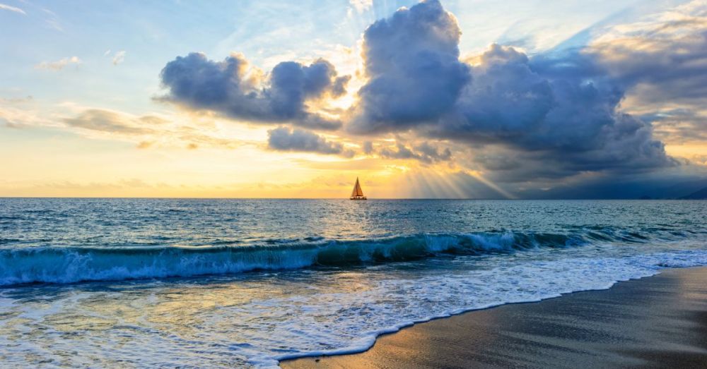 In the distance, there's a small boat sailing on the water while there is a dense group of clouds hanging above it.